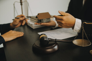 Justice and Law concept. Legal counsel presents to the client a signed contract with gavel and...