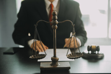 Justice and Law concept. Legal counsel presents to the client a signed contract with gavel and...