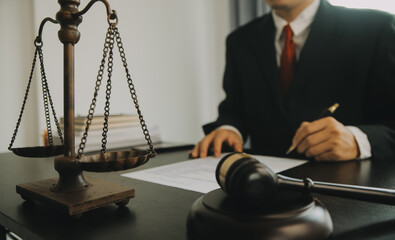 Justice and Law concept. Legal counsel presents to the client a signed contract with gavel and...