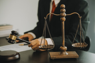 Justice and Law concept. Legal counsel presents to the client a signed contract with gavel and...