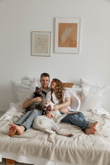 Couple in love, pregnant girl and guy with dogs, bright photo