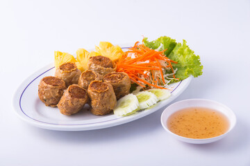 Deep fried crab meat rolls on the white dish.