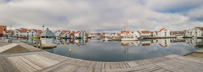 Houses and boats are reflected in the water