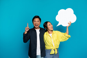 Glad young asian lady in casual hold abstract cloud with empty space, man got idea