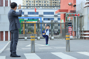 The father sent his son to school at the school gate