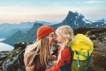 Fotobehang Family travel lifestyle mother hiking with daughter child outdoor active vacations backpacking in mountains parent and kid together tenderness and care © EVERST