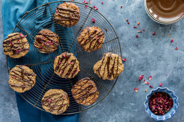 Above view of a cooling rack topped with chocolate drizzled lace cookie.