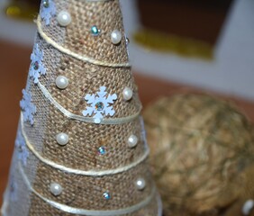 Christmas tree made of bagging and pearls, Christmas handmade fur tree close view, holiday background