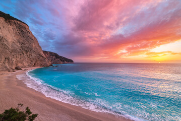 Beautiful beach and water bay in the greek spectacular coast line. Sunset gorgeous sky over blue water unique rocky cliffs. Greece summer top travel destination Lefkada island