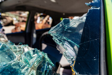 Close-up of the broken windshield of the car. An old abandoned car with a broken windows. Shards of...