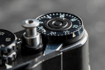 Fototapeta na wymiar Settings mechanism on mirror analog film camera. Rotation, using mechanical wheel. Vintage photo camera, 35mm film, made in USSR, closeup
