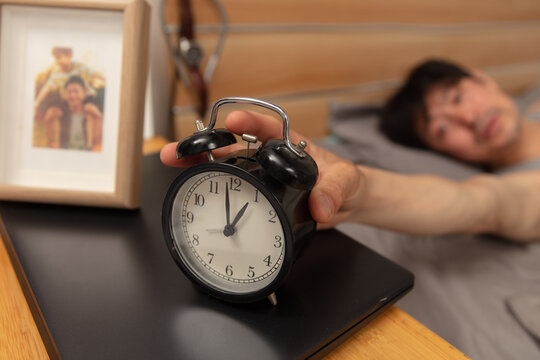 North drift middle-aged man presses alarm clock