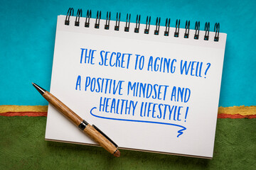 The secret to aging well? A positive mindset and healthy lifestyle! Inspirational note in a spiral notebook.