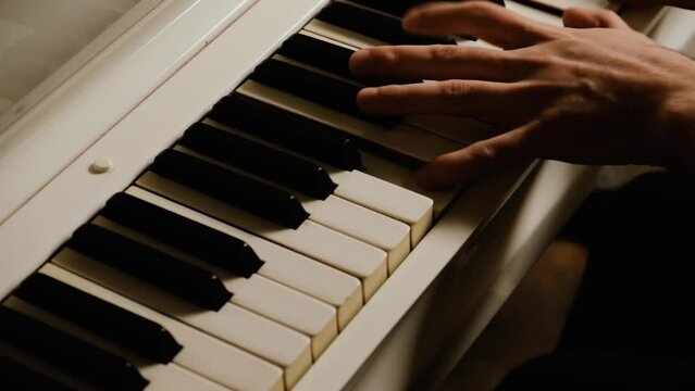 The musician's hand quickly moves over the claves of the piano. Close-up.