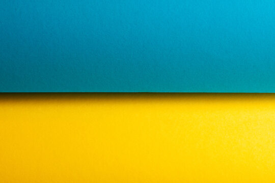 Rolls of splash paper for creativity. Two colours - light blue, lemon yellow. National flag of Ukraine. Text space. Close up. Studio shot