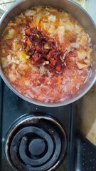 fresh borscht, red soup in a pan on the stove, home cooking, food