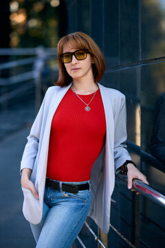 Close-up Portrait of Stylish Redhead Woman in Urban Autumn Fashion