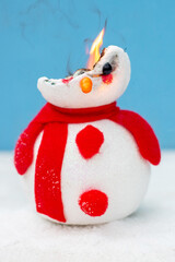 A toy snowman is on fire. Fire for the new year