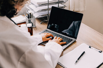 Online training. Young Latin American girl student doctor studies online at home from laptop