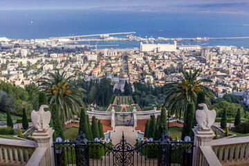 The Bahai gardens and Shrine of the Bab over the Israeli city of Haifa, naval port, downtown, and...