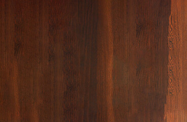 A close-up view of a wooden surface with a dark brown finish - obrazy, fototapety, plakaty