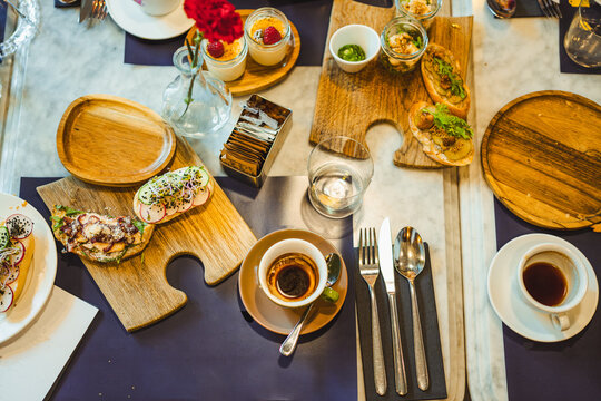 Breakfast restaurant table. Shot of the table from above. Warm bread and coffee. Drink and food.