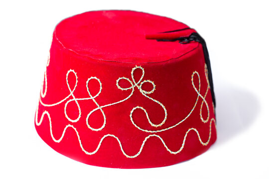 Red fez hat or tarbush hat with festive decoration isolated on the white background