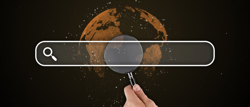 Human hand holds a magnifier in the search bar tab. Creative interface browser.