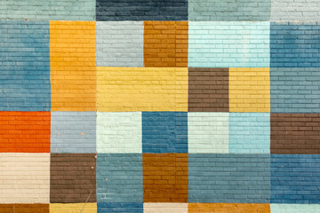 colorful brick wall in different colors in geometric pattern - obrazy, fototapety, plakaty