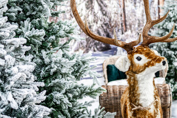 Winter holiday street decoration. Christmas store decoration. The figure of an artificial deer with...