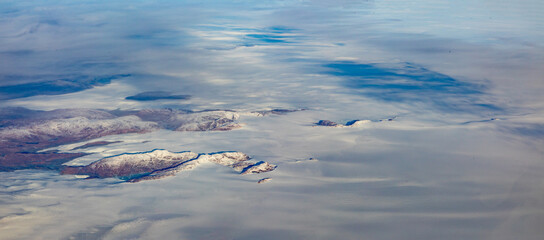 aerial of sunrise at snow landscape with mountains of Greenland