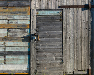 a wooden door with a lock is the entrance to the shed. village buildings.