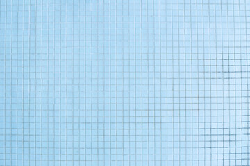 Texture of small blue swimming pool tiles for background. Wall and construction materials, masonry