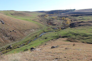 Fototapeta na wymiar A landscape with a river running through it