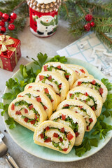 Creative appetizers christmas. Cheese roll with cream cheese, sweet pepper and greens.