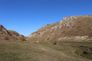 A grassy hill with a dirt road