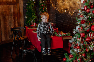 Obraz na płótnie Canvas Little boy with christmas tree and gifts