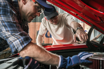 Classic Muscle Cars Enthusiasts Working on the Car Engine