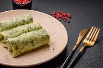 Delicious fresh pancakes with spinach, cream cheese, salmon, salt and spices