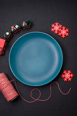 Ceramic round plate decorated with festive elements on the Christmas table