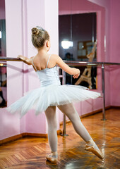 Graceful Elegance in Motion. A young ballerina in a white tutu and ballet shoes © Vadim