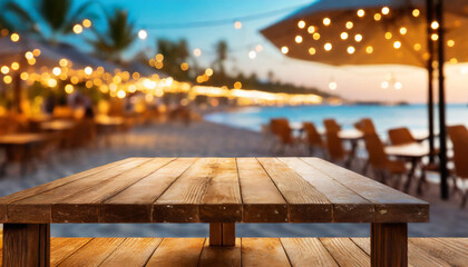 wooden table and blur beach cafes background with bokeh lights high quality photo