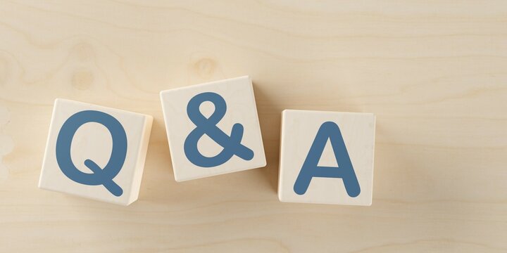 Wooden blocks with the letters q&a on wooden table background, question and answer business concept, flat lay top view from above
