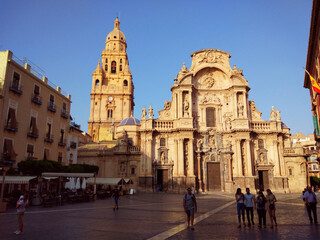 Fototapeta na wymiar An afternoon in the square and main facade of the cathedral of Murcia, in Spain
