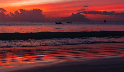 Panoramic night beach landscape, shore water under red tropical sky at sunset