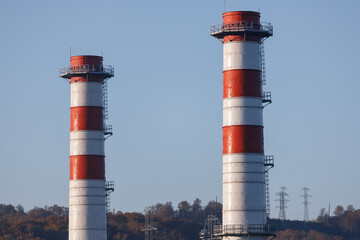 Power plant with two red and white pipes