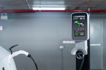 EV electric car recharge at shopping center parking lot charging in downtown city showing urban...