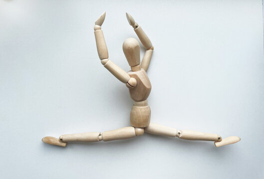 Wooden puppet in leg-split - Powered by Adobe