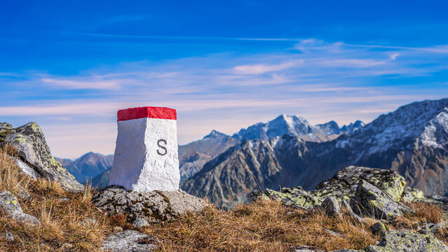 The boundary stone on the ridge of high mountains. The mountain ridge of the Western Tatras is a natural Poland and Slovakia border.