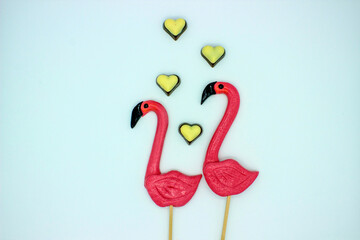 Two flamingo-shaped lollipop candies